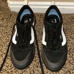 Men’s black and white Vans.